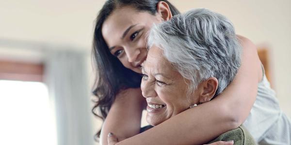 Woman hugging an older woman smiling
